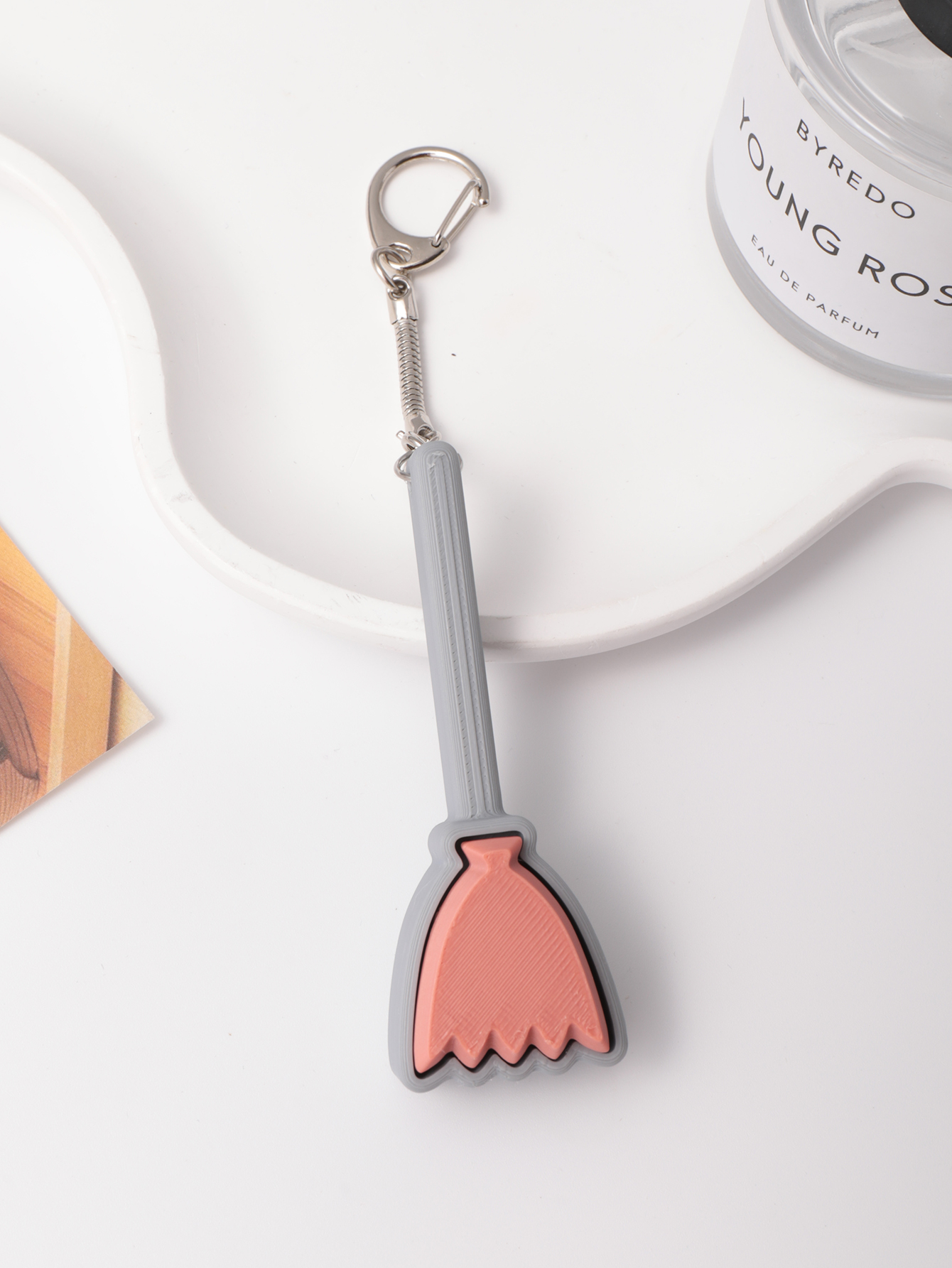 3D printed broom-shaped keychain - an adult stress relief toy with a portable anxiety relief gadget featuring a clickable keyboard design