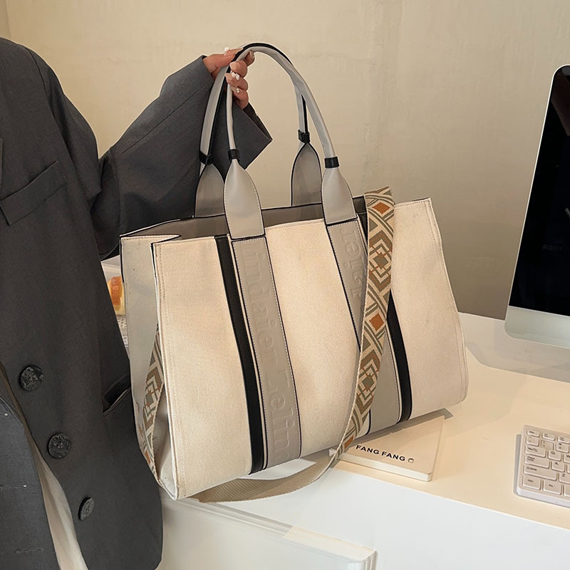 Large capacity hand-held canvas bag women's simple commuter tote bag with wide shoulder strap one-shoulder crossbody bag is versatile2025