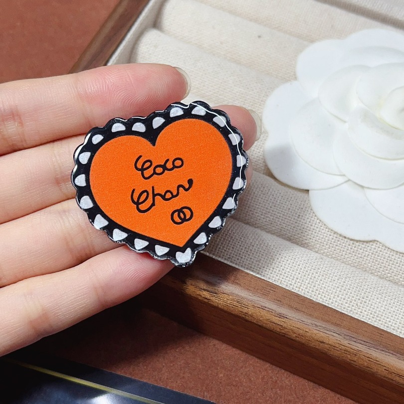 Orange Heart Shaped Brooch With Black Trim And Lettering Stylish Fashion Accessory And Party Decor Gifts For Her High Quality And Trendy Jewelry
