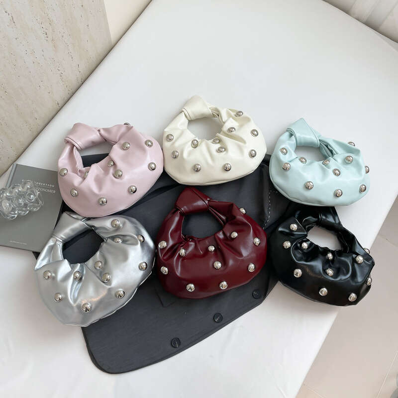 Handheld Dumpling for Women 2025 Summer New Hot Girl Niche Design Rivet Single Shoulder Underarm Bag