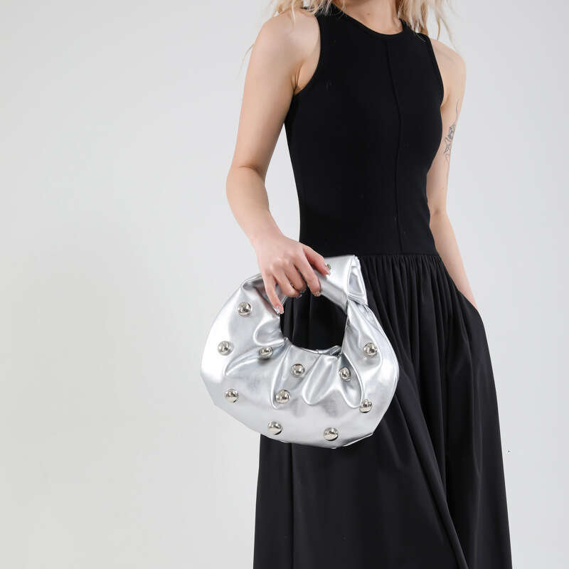 Handheld Dumpling for Women 2025 Summer New Hot Girl Niche Design Rivet Single Shoulder Underarm Bag