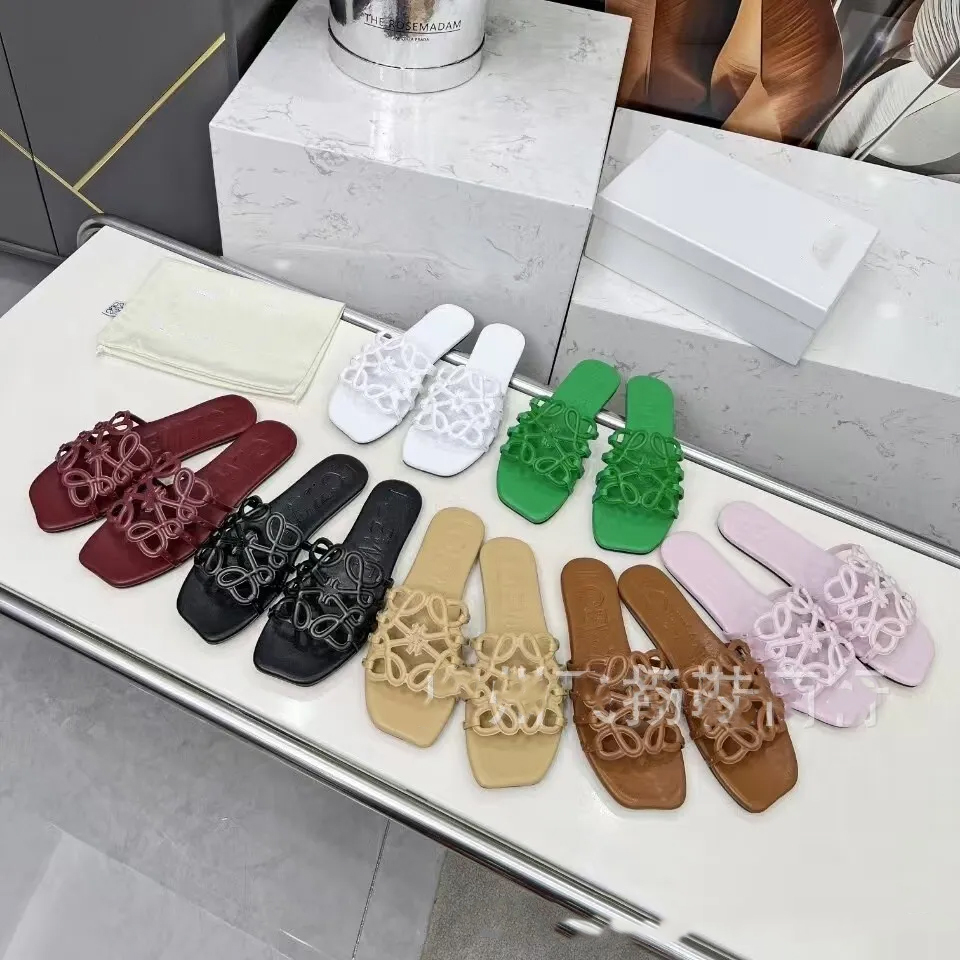 Designer slippers 26ss new hollowed out flat belt sandals for women, fashionable and simple design, beach Roman shoes, open toe slippers