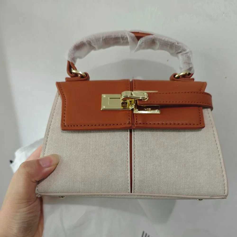 2025 JW PEI Trapezoidal Leather Womens Bag hot Versatile Crossbody Fashionable Niche Handbag Top-handle Bags C250401