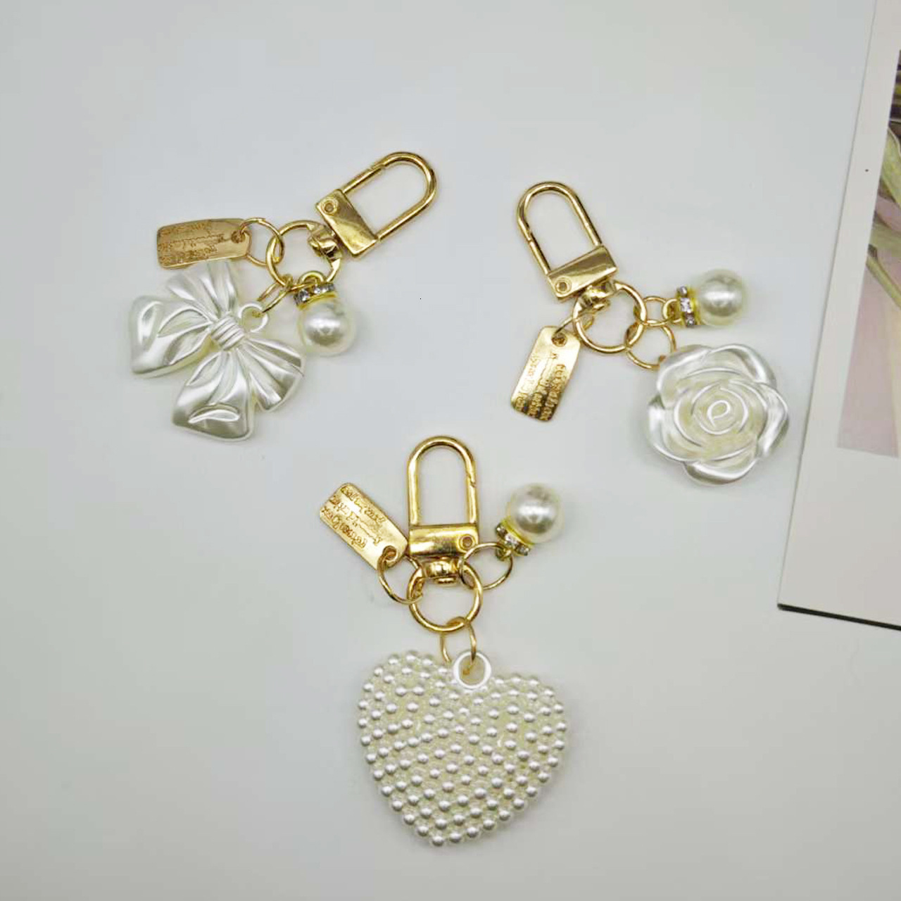 designer bag charm New Pearl Alloy Keychain Creative Hollow Heart Nameplate Accessories Earphone Case Bag Decoration Pendant keychain designer