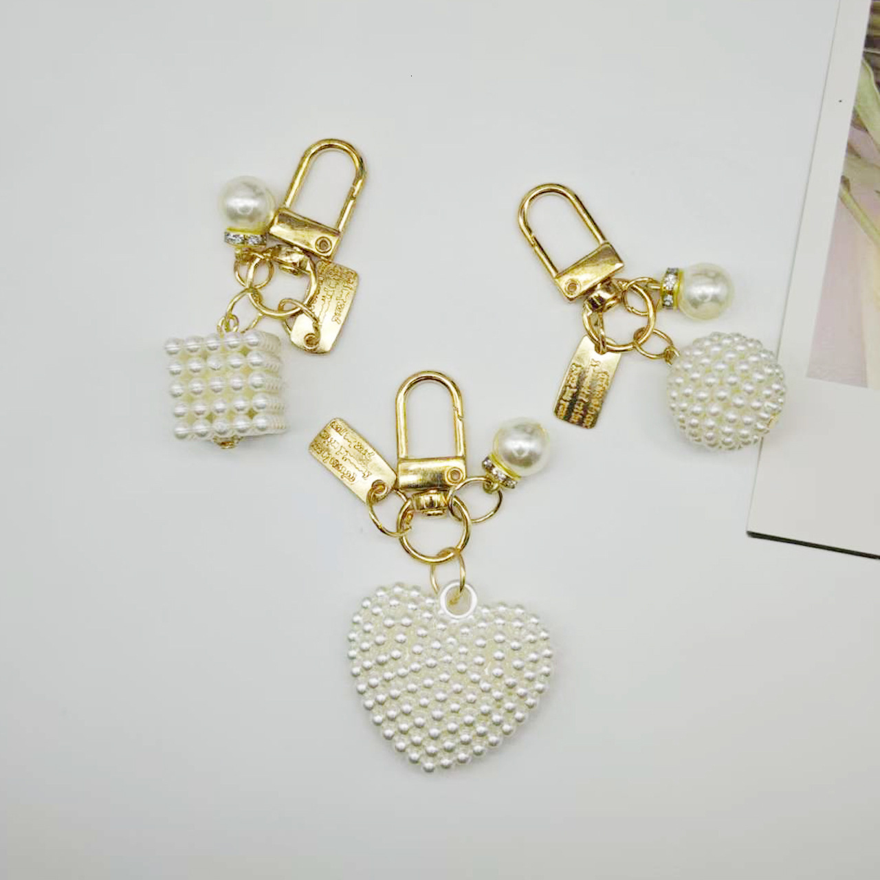 designer bag charm New Pearl Alloy Keychain Creative Hollow Heart Nameplate Accessories Earphone Case Bag Decoration Pendant keychain designer