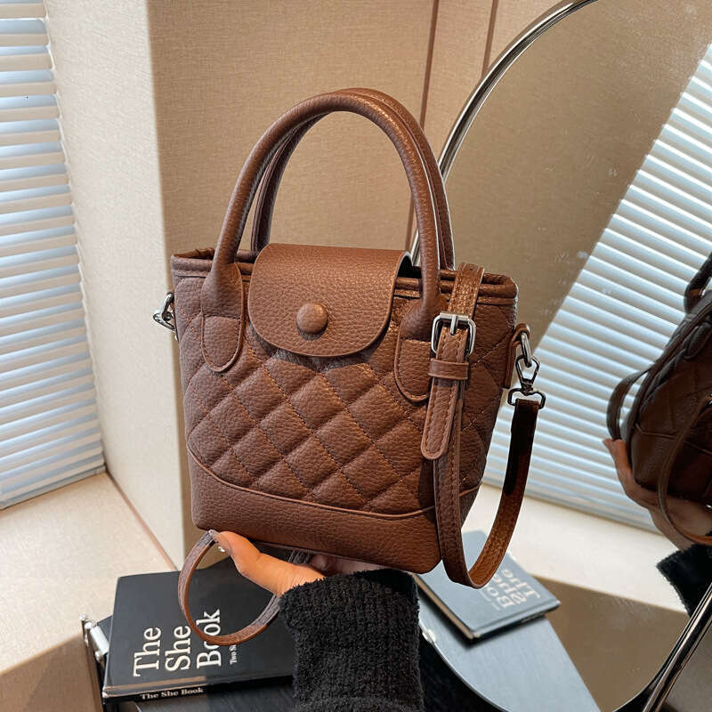 Korean version of niche hand-held bucket for women's spring new fashion versatile and high-end single shoulder crossbody bag