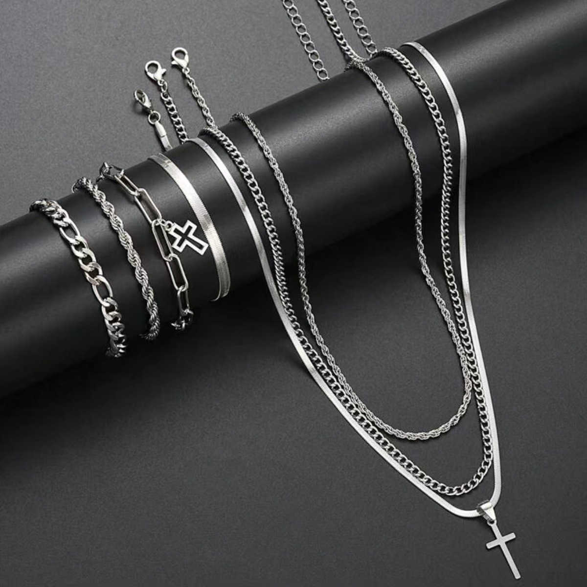 European and American best-selling 7-piece fashionable and simple stainless steel necklace and bracelet set. Smooth cross design.