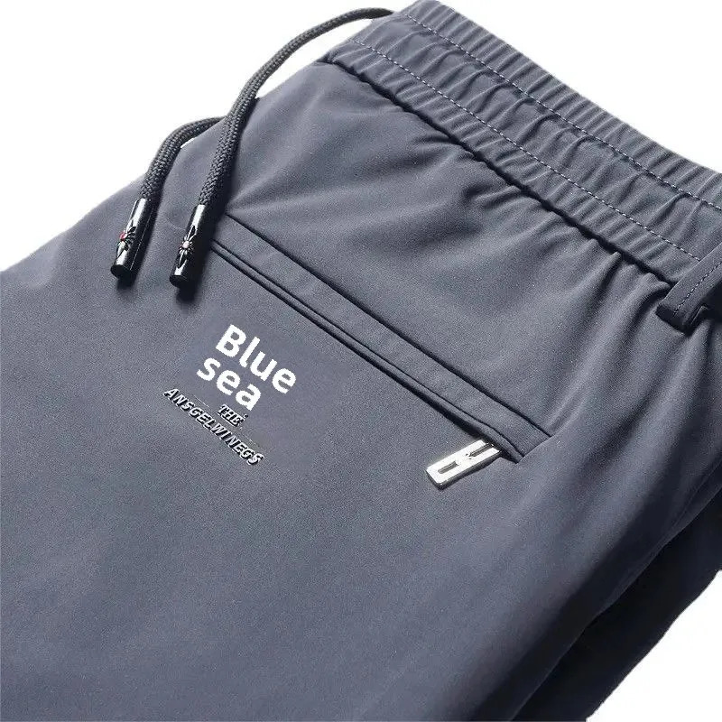 Mens casual elastic waist sports pants with loose fit for business travelers ice silk spring and summer slim mens sports pants 250402