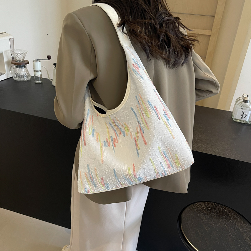 2025S Designer Women S Bag Small Niche Design Canvas Women S Summer Large Capacity New Versatile Armpit Bag High End Single Shoulder Bag