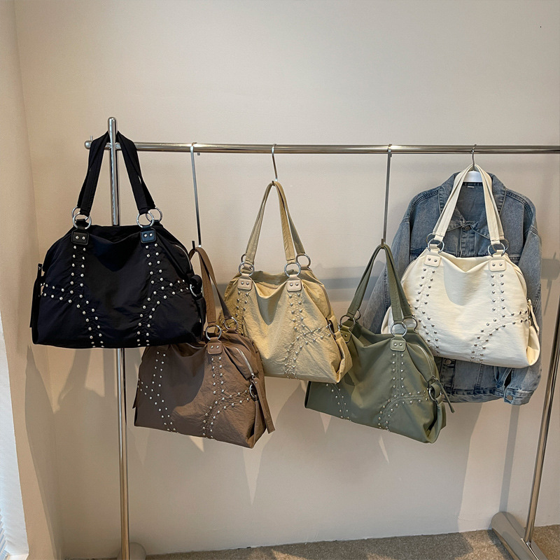 2025S Designer Women S Bag Autumn Popular Soft Cloth Rivet Shoulder Fashionable Large Capacity Tote Bag Casual Versatile Commuting Armpit Bag