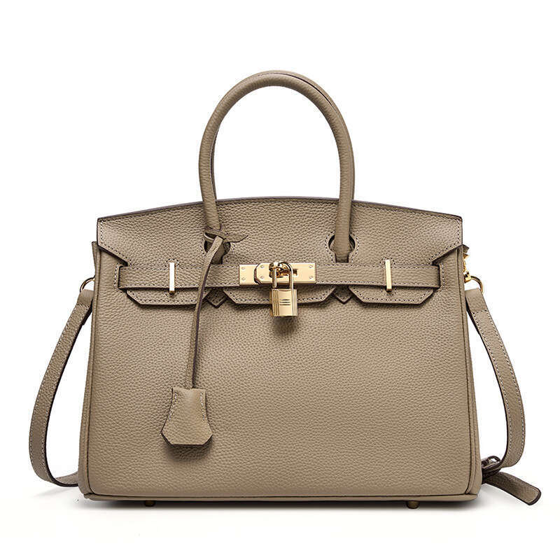 Large lychee patterned platinum wrapped cowhide large capacity Kelly handbag, women's trend, 2025 new style, chic and elegant clothing