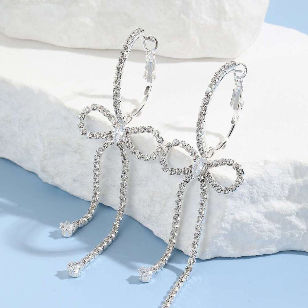 Korean socialite's urious and hot high-end style with dia studded bow, long tassel earrings, niche design, temperament, rhie earrings