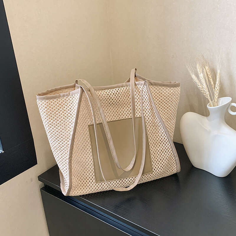 Design sense grass woven for women with large capacity hollowed out single shoulder beach bun mother commuting tote bag 2025 new casual versatile fash