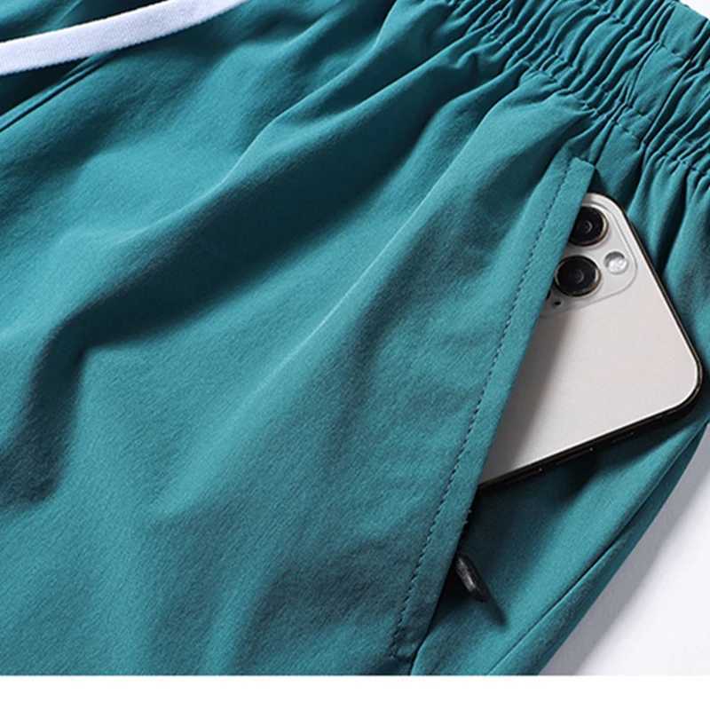 2024 Summer Mens Casual Split Beach Shorts for Sports Fitness Running Elastic Quick Drying Ice Silk Solid Color Quick DryingXJ250407