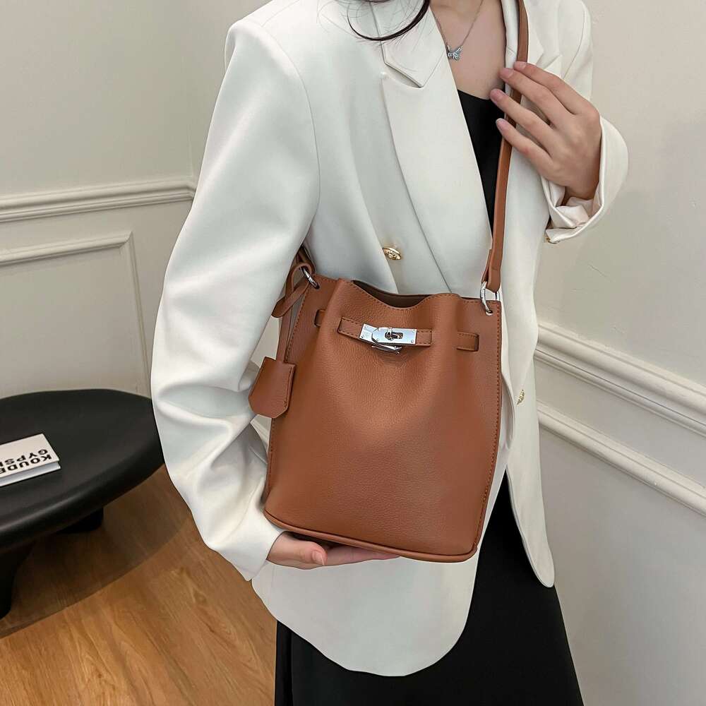 Simple Bucket Bag For Women's Daily Outings. A High - Quality Leather Bucket Bag In A Deep Brown Color, Exquisitely Adorned With