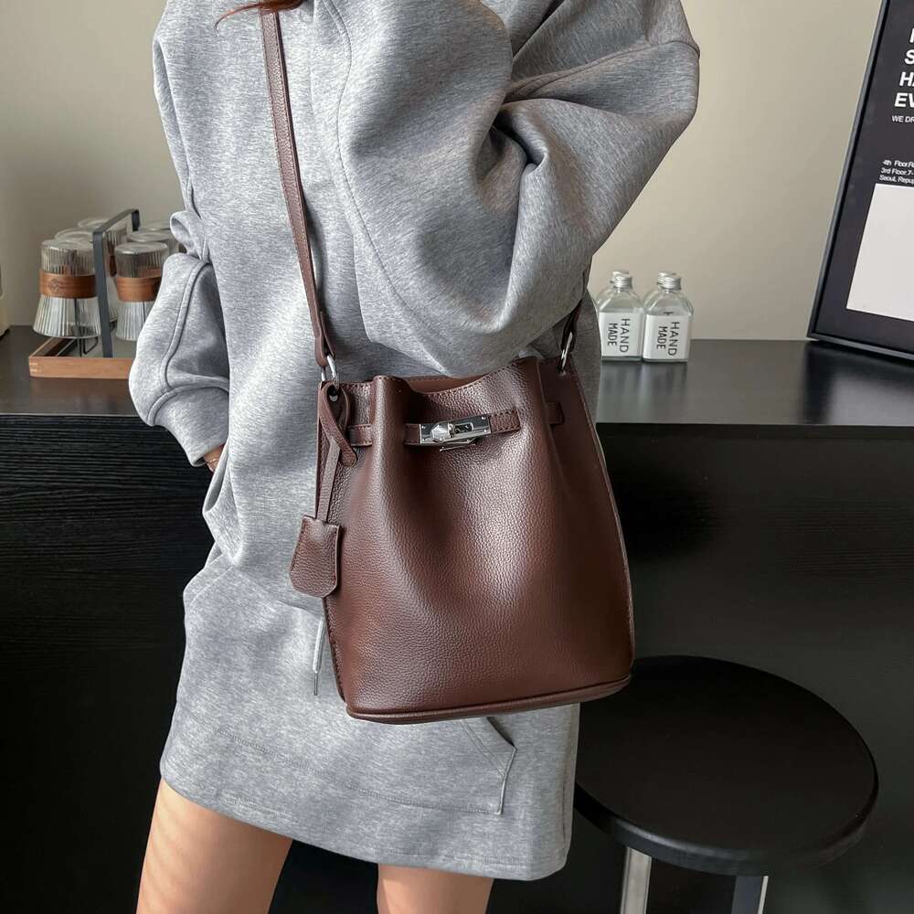 Simple Bucket Bag For Women's Daily Outings. A High - Quality Leather Bucket Bag In A Deep Brown Color, Exquisitely Adorned With