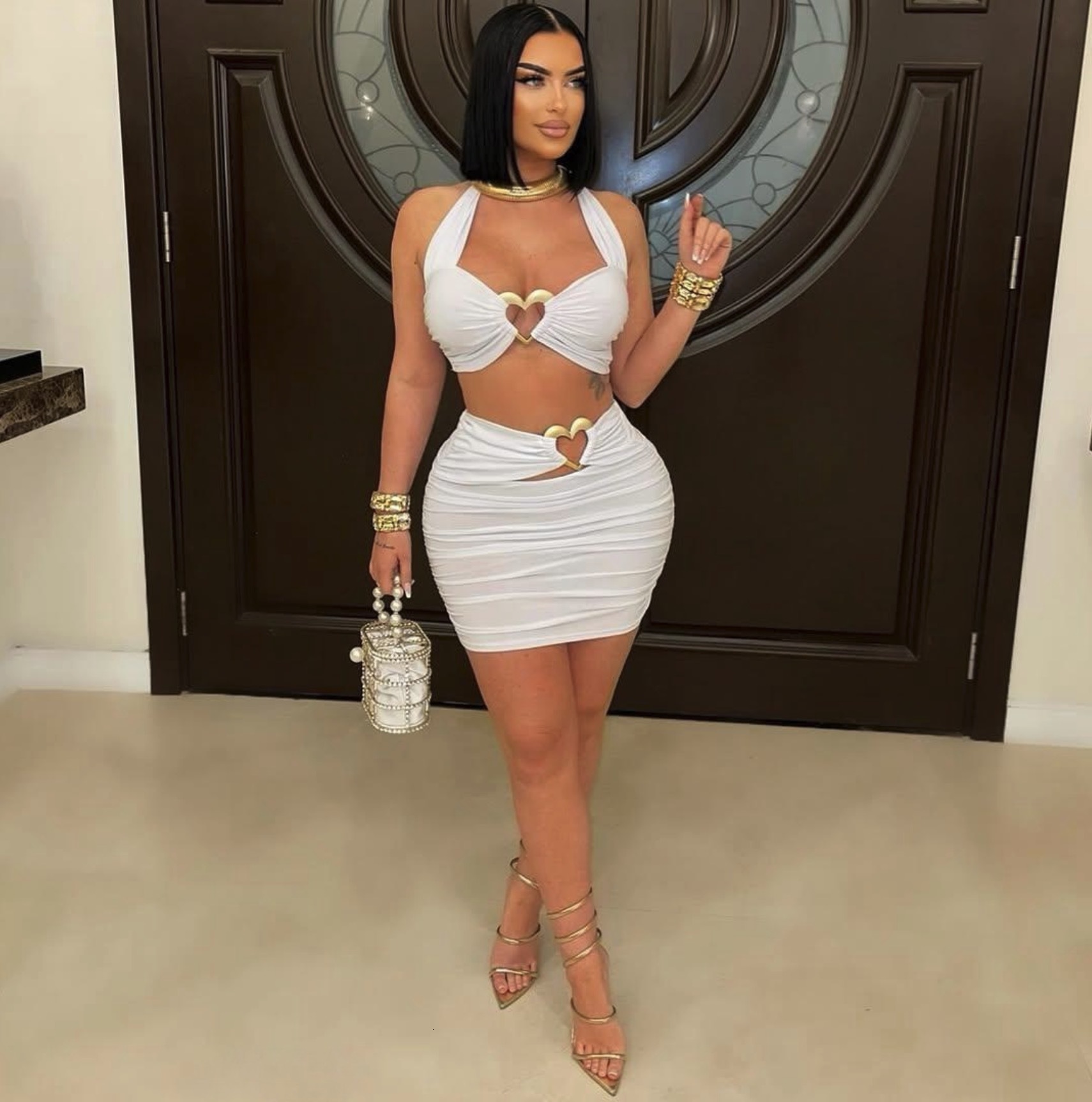 2025S Designer Women S Set New Solid Color Fashionable Slim Fit Sexy Metal Hanging Neck Short Top Hip Hugging Skirt Set