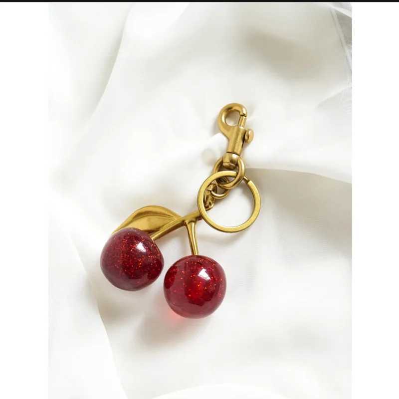 Red cherry pendant keychain womens cute packaging decoration multifunctional jewelry car key Accor Tren charm keychainXJ250409