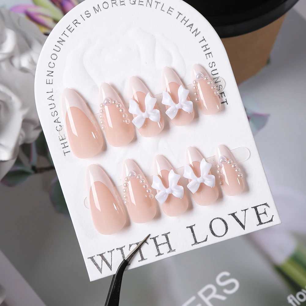 24 pieces (+tools) Pearl Bow Nude Pink Pressing Nails White French Fingertips Almond Full Set Fasle Nail New Year Nail Accessories W250410