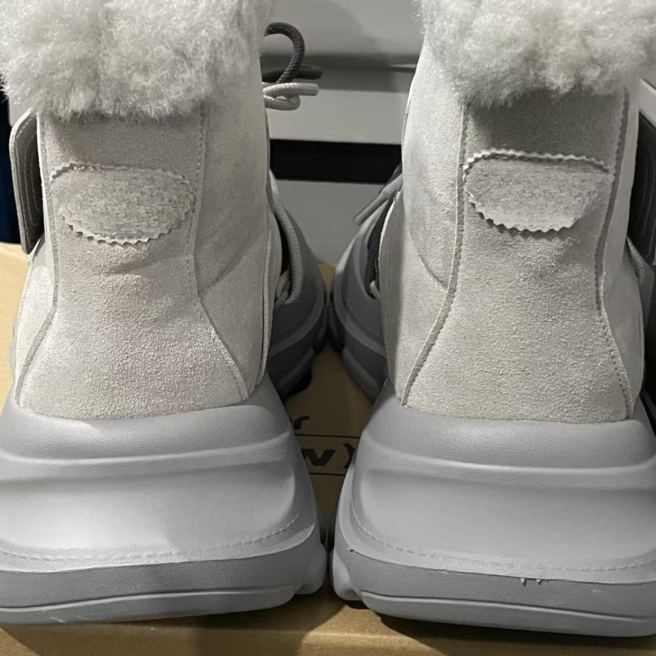 Designer snow boots with closed toe, thick sole, increased warmth, lace up, waterproof, anti slip, cowhide, wool, designer shoes