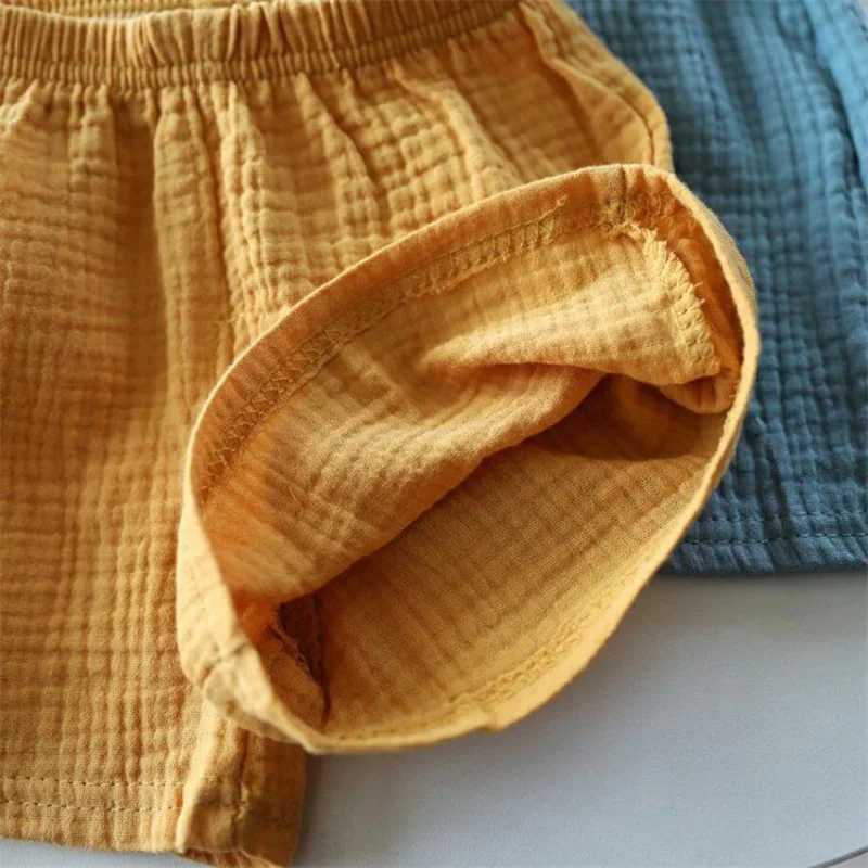 Cotton linen childrens girls shorts solid color summer boys five point pants childrens baby clothing Z250410