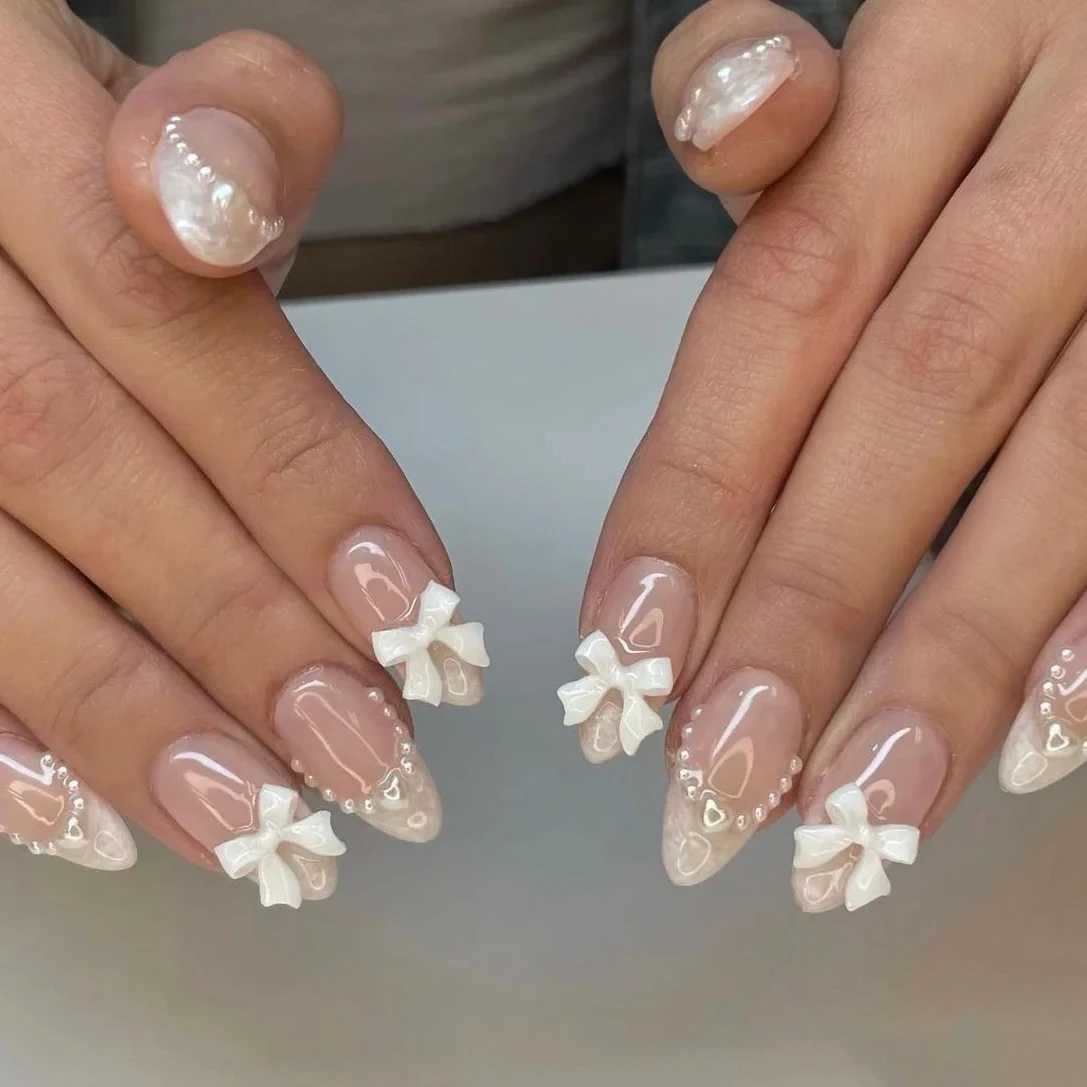 24 pieces (+tools) Pearl Bow Nude Pink Pressing Nails White French Fingertips Almond Full Set Fasle Nail New Year Nail Accessories W250410