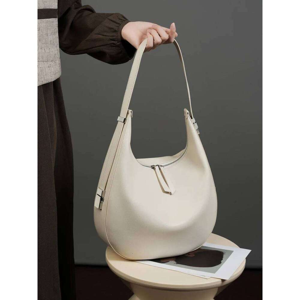 2025 spring/summer new niche design cowhide underarm shoulder hand-held leather crescent bucket women's bag