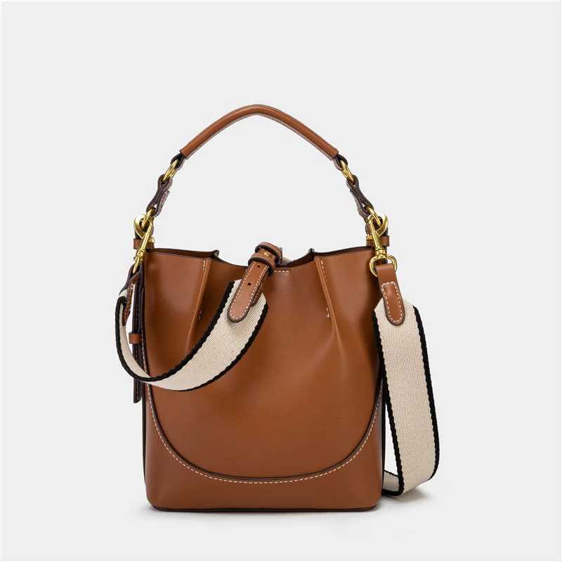 Spain 2025 new womens bag brown pleated drawstring versatile hand-held bucket bag wide shoulder strap diagonal cross bagT251110