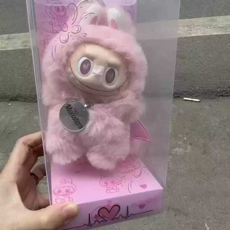 Zimomo Transforms Into A Baby With Blue Puffs And Pink Hearts Labubu Is A Plush Toy Made Of Vinyl With A Blue And Pink Leader W250411