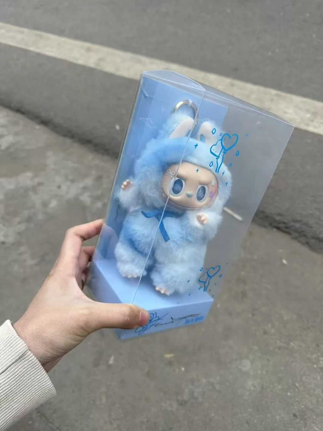 Zimomo Transforms Into A Baby With Blue Puffs And Pink Hearts Labubu Is A Plush Toy Made Of Vinyl With A Blue And Pink Leader W250411