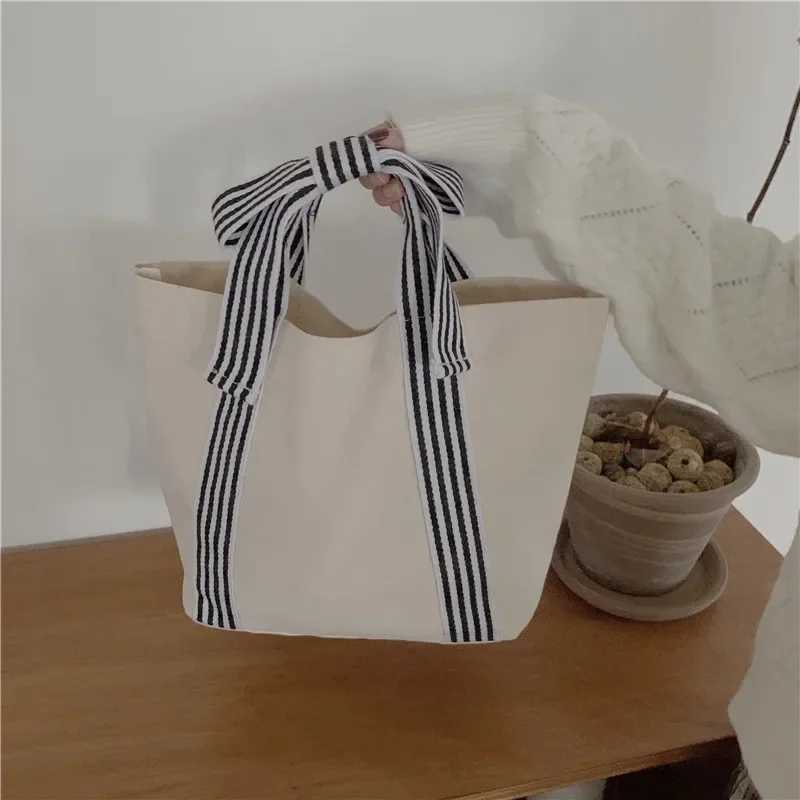Fi Joker Korean style bag bow canvas bag lunch bag simple small fresh handbag womens bagXJ250412