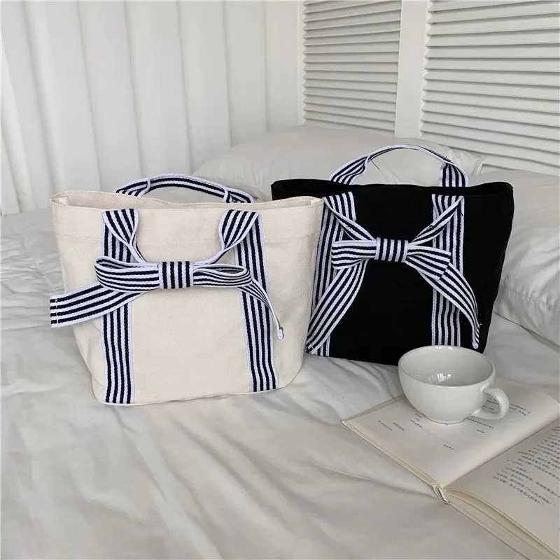 Fi Joker Korean style bag bow canvas bag lunch bag simple small fresh handbag womens bagXJ250412