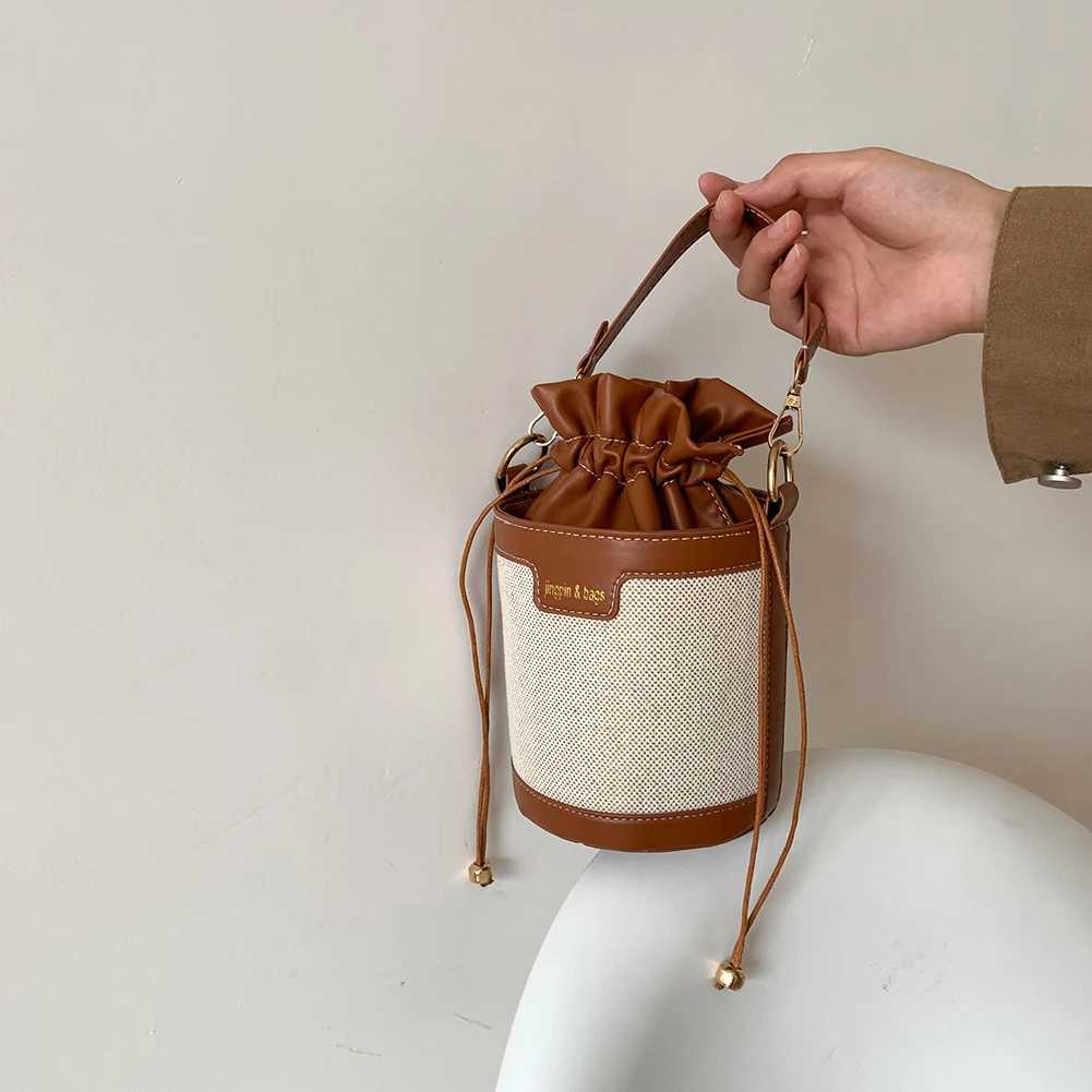 Womens retro cylindrical shoulder bag Drstring bucket leather cross body bagXJ250412