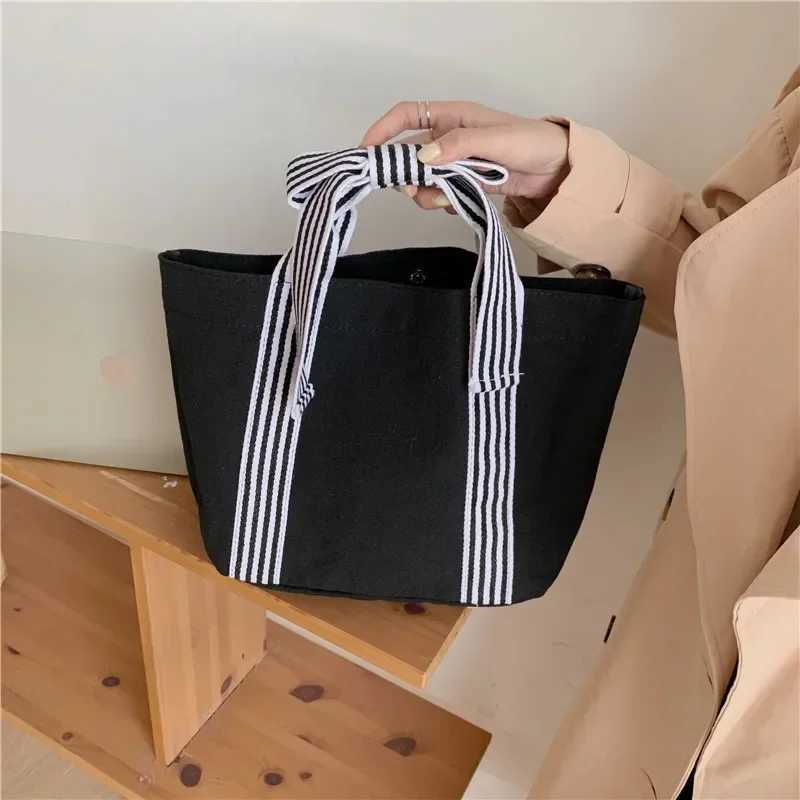 Fi Joker Korean style bag bow canvas bag lunch bag simple small fresh handbag womens bagXJ250412