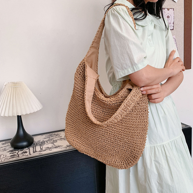 2025S Designer Women S Bag Spring And Summer Vacation Style Tote Grass Woven Shopping Women S Hand Held Beach Versatile Solid Color Shoulder Bag
