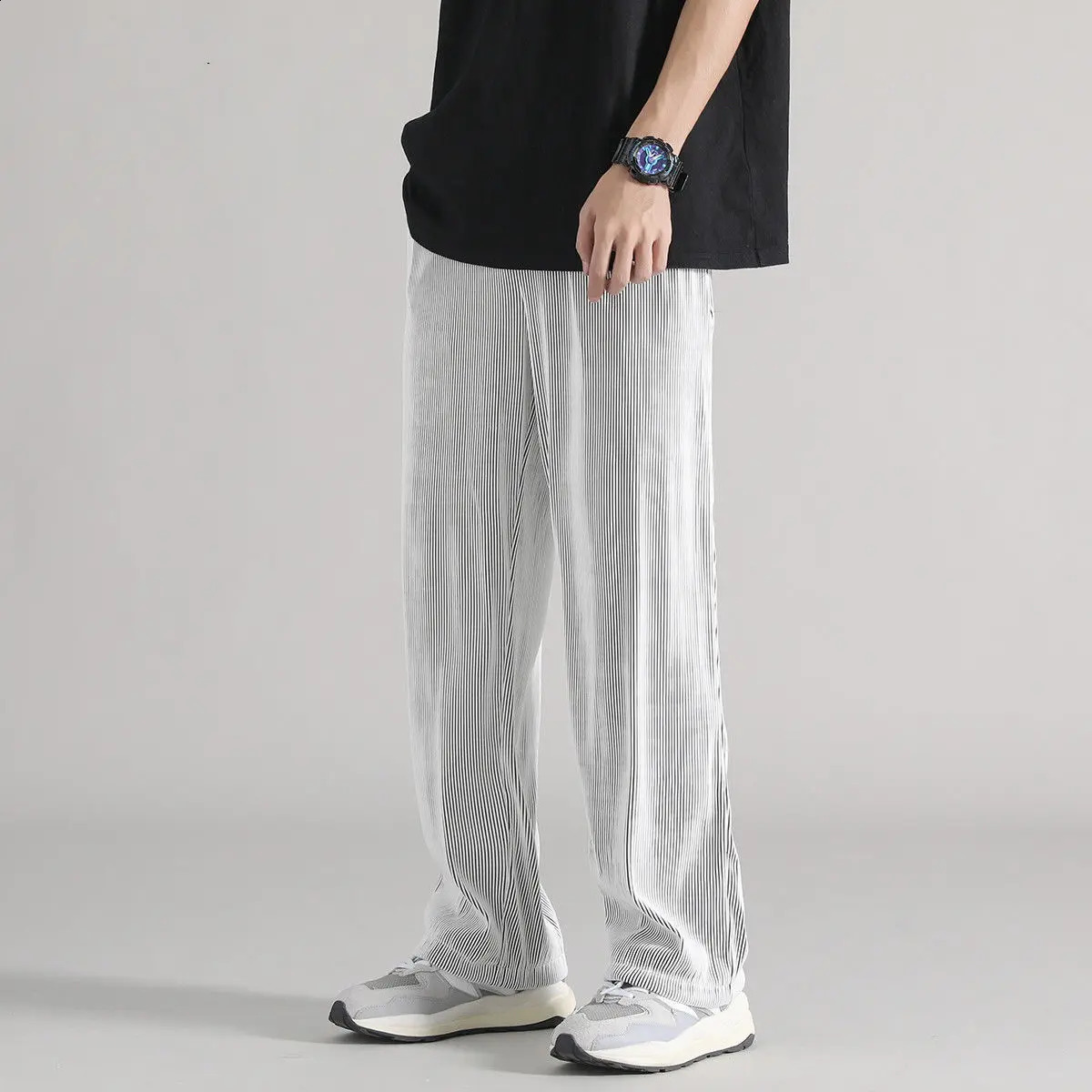 Ice silk pants for men in summer thin and loose with a light beam and drooping feet. Quick drying and casual mens Trouser trend. Nine oclock harem spo
