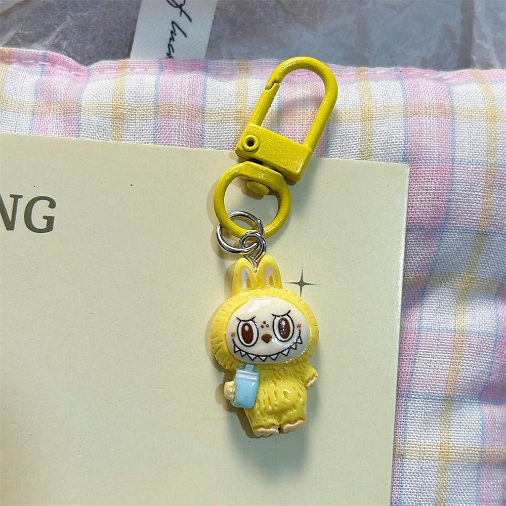 Cute Labubu Keychain on Drinking Milk Tea Cup - Colorful Cartoon Doll Pendant for Student Backpacks