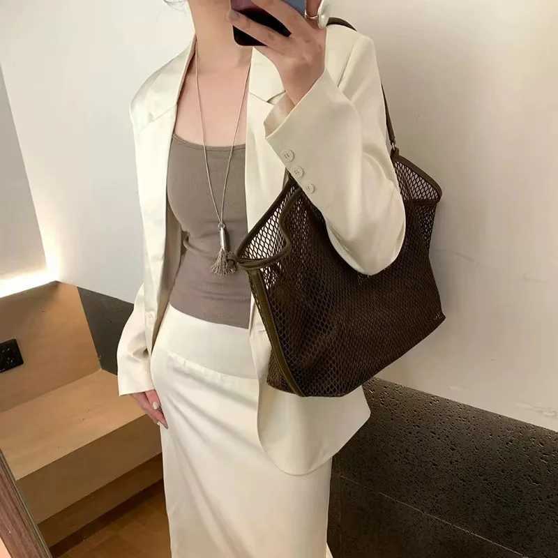 Designer womens mesh handbag large capacity womens commuting shoulder bag spring and summer new casual vacation lazy style handbag W250415