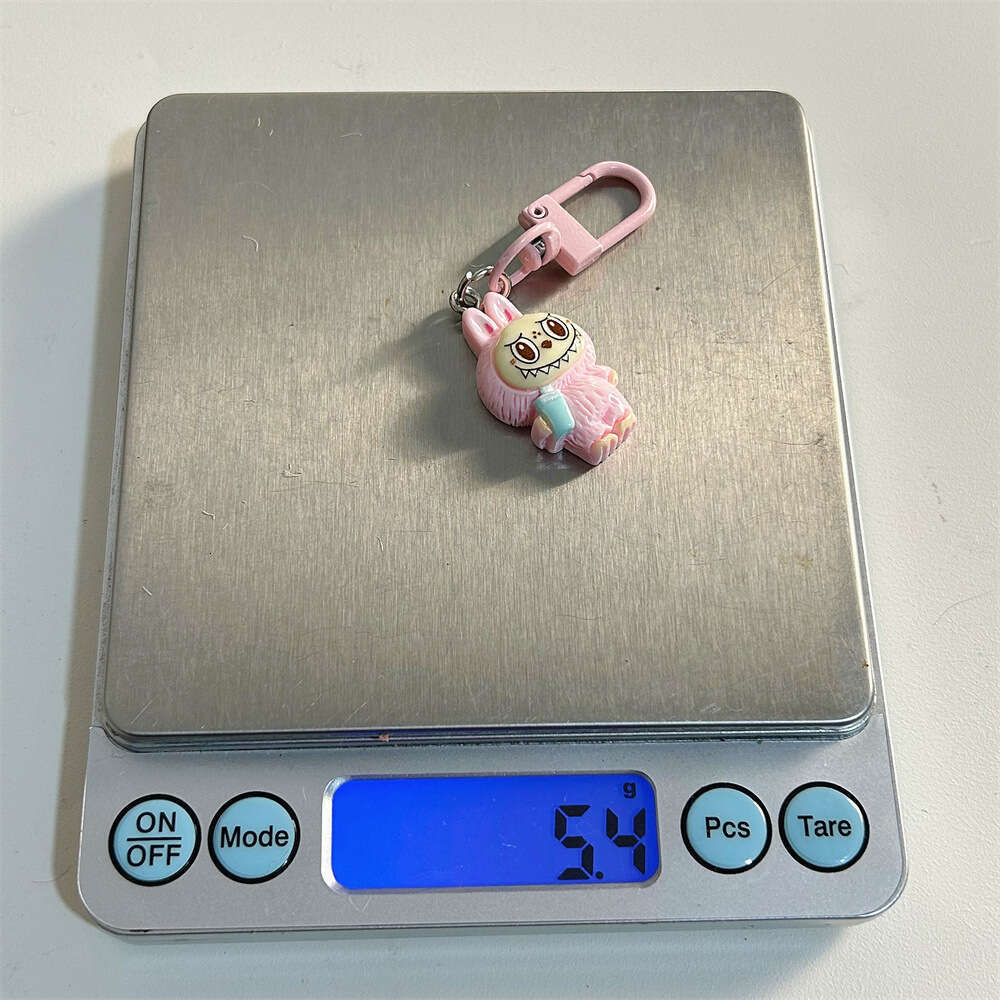 Cute Labubu Keychain on Drinking Milk Tea Cup - Colorful Cartoon Doll Pendant for Student Backpacks