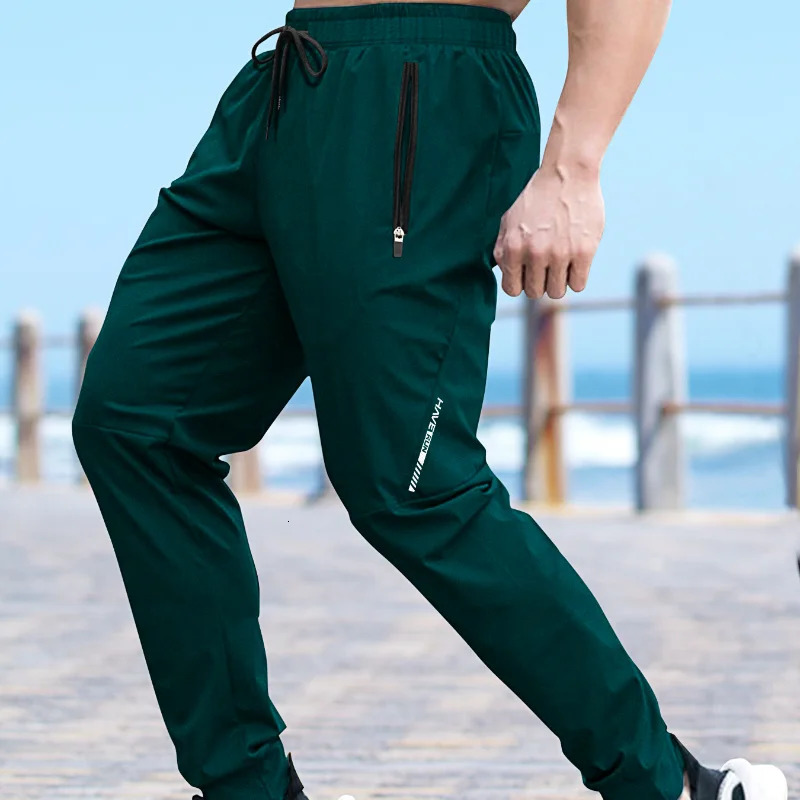 Mens summer quick drying silk casual pants mens ultra-thin elastic nine point loose zipper solid color mens clothing 250410
