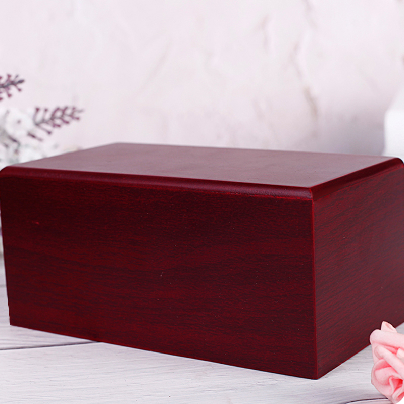 An eco-friendly red solid wooden pet caskets with a removable drawer feature. It is a pet coffin and urn made of sturdy solid wood material Suitable f
