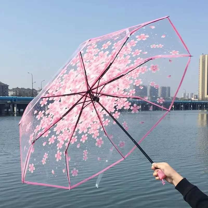 This transparent cherry blossom umbrella features a stylish and unique three-fold design presenting a fresh and simple aestheticM251122