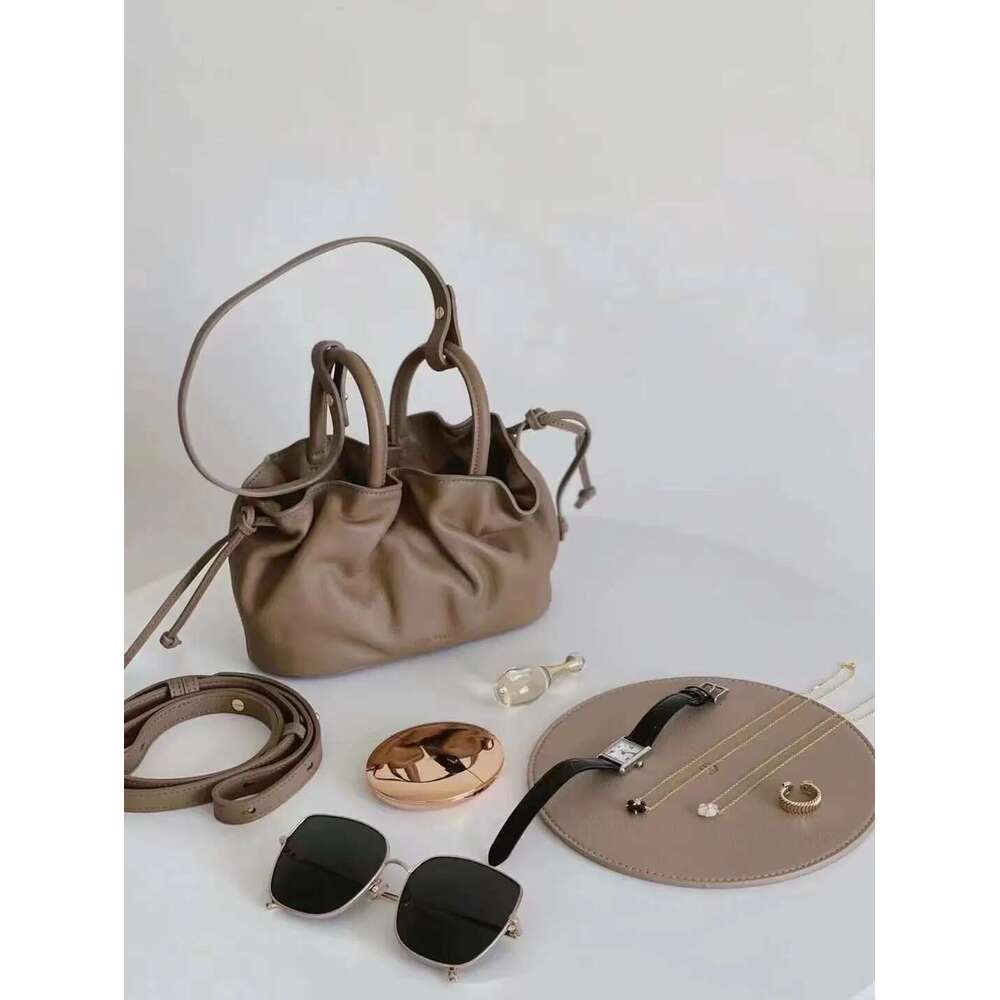 2025 New Mini Wrinkle Texture Handheld Women's With Genuine Leather Streamed Leisure One Shoulder Oblique Straddle Bag Designer's bag Design