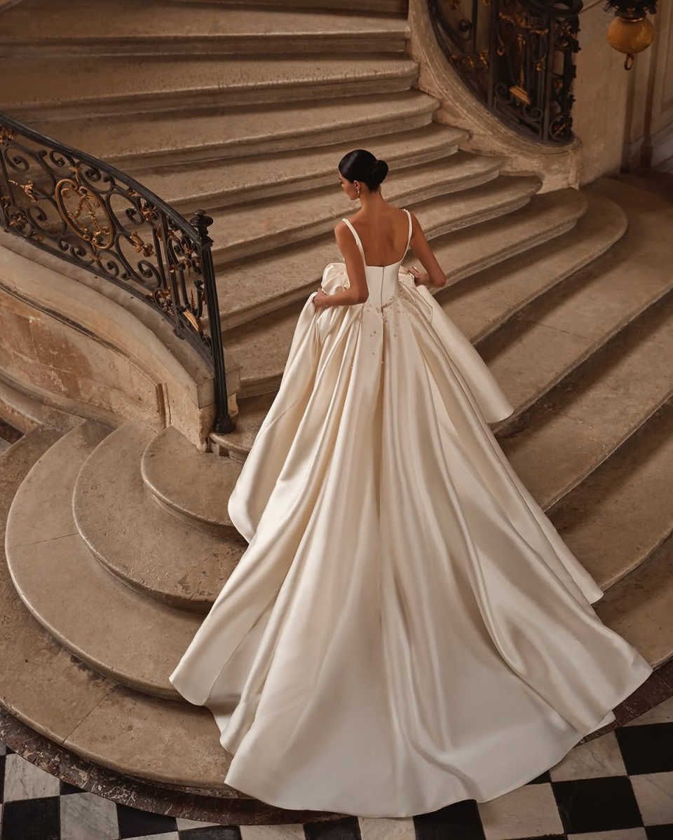 2026 New Charming A Line Wedding Dresses Pearls Beading Satin Spaghetti Straps Bridal Gowns Backless Pleats Bride Dress F04