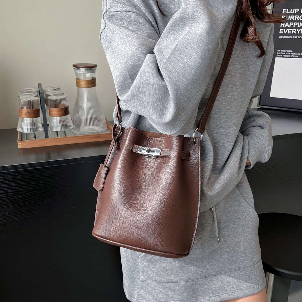 Simple Bucket Bag For Women's Daily Outings. A High - Quality Leather Bucket Bag In A Deep Brown Color, Exquisitely Adorned With