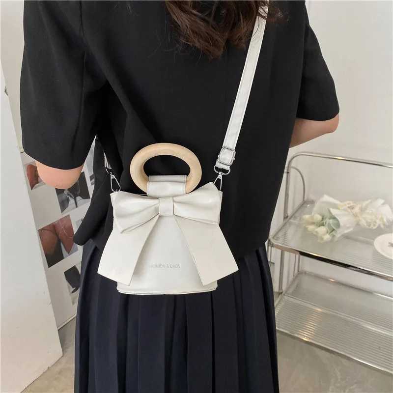 Sweet Bow Tie Designer Mini Shoulder Circumcision Leather Bucket Cross Body Bag Womens Fashion Luxury Brand Handbag Womens Handbag W250421