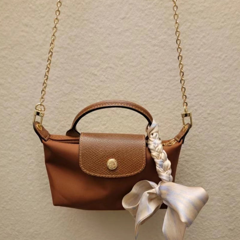 Designer 2025S women dragon dumpling new mini short handle handbag shoulder crossbody mobile phone change makeup bag