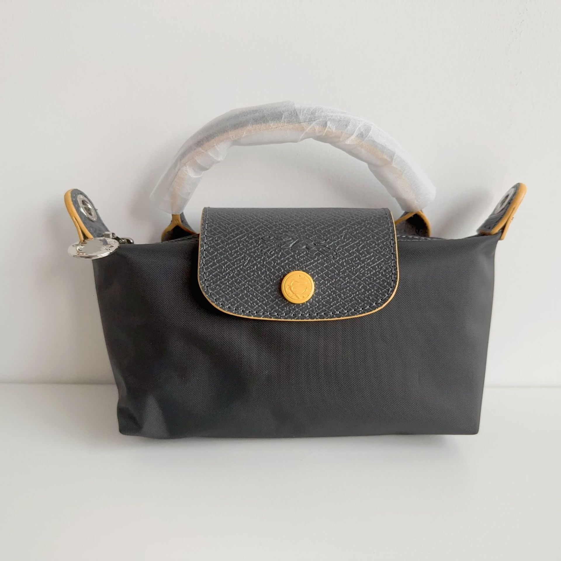 Designer 2025S women dragon dumpling new mini short handle handbag shoulder crossbody mobile phone change makeup bag