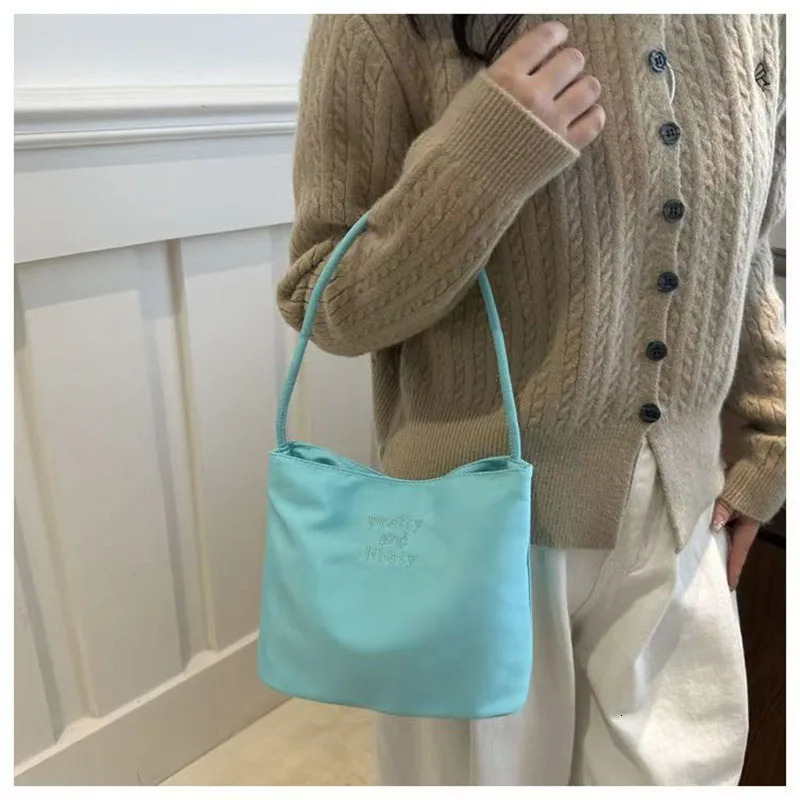 Korean papaya and ebony fashionable embroidery high elasticity waterproof nylon versatile casual womens shoulder bag 250427