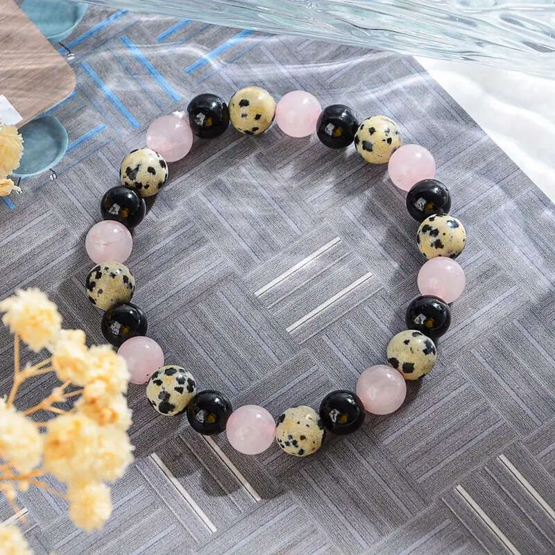 Temu Xiyin's new pink speckled obsidian bead bracelet with map and white string, let go
